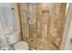 Bathroom with a walk-in shower enclosed in glass, tile walls, built-in seat, and convenient grab bar at 20 Whispering Sands Dr # 406, Sarasota, FL 34242
