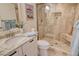 Stylish bathroom featuring a tiled glass shower, granite countertop and a vessel sink at 20 Whispering Sands Dr # 406, Sarasota, FL 34242