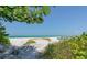 Picturesque beach access with lush greenery and tranquil ocean views at 20 Whispering Sands Dr # 406, Sarasota, FL 34242