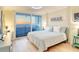 Bedroom featuring a sliding glass door to a balcony overlooking the beach and ocean sunset at 20 Whispering Sands Dr # 406, Sarasota, FL 34242