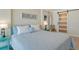 Cozy bedroom with queen bed, beach themed decor, and a sliding barn door for a relaxing retreat at 20 Whispering Sands Dr # 406, Sarasota, FL 34242