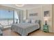 Inviting bedroom with beach view, modern décor, and access to a private balcony at 20 Whispering Sands Dr # 406, Sarasota, FL 34242