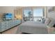 Light-filled primary bedroom features a relaxing color palette and direct ocean views at 20 Whispering Sands Dr # 406, Sarasota, FL 34242