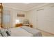 Cozy bedroom with warm lighting, a comfortable chair, and neutral decor at 20 Whispering Sands Dr # 406, Sarasota, FL 34242