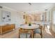 Charming dining area with a modern light fixture, comfortable seating, and an open view of the kitchen at 20 Whispering Sands Dr # 406, Sarasota, FL 34242