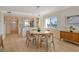 Inviting dining area with contemporary lighting, a round table, and views of the modern kitchen at 20 Whispering Sands Dr # 406, Sarasota, FL 34242