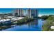 Scenic view of condos with a pond reflecting the building and lush greenery at 20 Whispering Sands Dr # 406, Sarasota, FL 34242