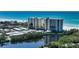 Scenic view of condos with a pond reflecting the building and lush greenery at 20 Whispering Sands Dr # 406, Sarasota, FL 34242