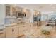 Open kitchen features granite countertops, modern appliances, and an island with a sink at 20 Whispering Sands Dr # 406, Sarasota, FL 34242