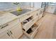 Kitchen cabinets and drawers with modern hardware offer ample storage space at 20 Whispering Sands Dr # 406, Sarasota, FL 34242