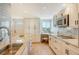 Well-lit kitchen boasts granite countertops, stainless steel appliances, and stylish backsplash at 20 Whispering Sands Dr # 406, Sarasota, FL 34242