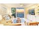 Inviting living room with ocean views from the balcony, featuring built-ins and comfortable seating at 20 Whispering Sands Dr # 406, Sarasota, FL 34242