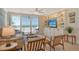 Cozy living room with ocean view, comfortable seating, and built-in shelving at 20 Whispering Sands Dr # 406, Sarasota, FL 34242