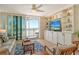 Bright living room boasts built-in shelving, beachy decor, and balcony access with beautiful ocean views at 20 Whispering Sands Dr # 406, Sarasota, FL 34242