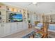 Cozy living area featuring custom built-ins, elegant decor, and seamless flow to the adjacent kitchen at 20 Whispering Sands Dr # 406, Sarasota, FL 34242