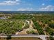 Aerial view of a large treed property with a pond at 22520 61St E Ave, Bradenton, FL 34211