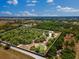Aerial view of a large treed property with a pond at 22520 61St E Ave, Bradenton, FL 34211