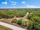 Aerial view of the property featuring beautiful trees and a peaceful pond on the land at 22520 61St E Ave, Bradenton, FL 34211