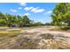 The property features a lot with lots of mature trees and an abundance of space to build at 22520 61St E Ave, Bradenton, FL 34211