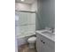 Bathroom featuring a shower with sliding glass doors, tiled walls, and a modern vanity at 2510 N Osprey Ave, Sarasota, FL 34234