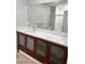 Bathroom vanity featuring wood cabinets, a white countertop, modern sink, and large mirror at 2510 N Osprey Ave, Sarasota, FL 34234
