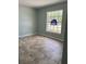 Bedroom featuring tile floors and a window; an 'Open Sunday' sign is posted in the window at 2510 N Osprey Ave, Sarasota, FL 34234