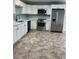 Modern kitchen featuring stainless steel appliances, white cabinets, and stylish countertops at 2510 N Osprey Ave, Sarasota, FL 34234