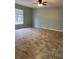 Well-lit living room boasting tile floors, a ceiling fan, and a large window at 2510 N Osprey Ave, Sarasota, FL 34234