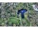 Beautiful aerial view of a pond with a fountain, foot bridge, walking paths, and lush landscaping at 2610 Jefferson Cir, Sarasota, FL 34239