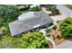 Aerial view of a well-maintained home with mature landscaping and neutral roof at 2610 Jefferson Cir, Sarasota, FL 34239