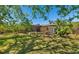 Expansive backyard with lush greenery and a screened-in lanai, perfect for outdoor relaxation at 2610 Jefferson Cir, Sarasota, FL 34239