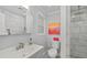 Beautiful bathroom with modern fixtures, tiled shower, and mosaic tile flooring at 2610 Jefferson Cir, Sarasota, FL 34239
