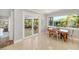 Open-concept dining area with views of the lanai featuring bright light and modern decor at 2610 Jefferson Cir, Sarasota, FL 34239