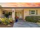 Inviting front entrance with decorative plants, stylish sconces, and light green trim at 2610 Jefferson Cir, Sarasota, FL 34239