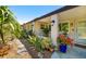 Inviting home exterior featuring lush tropical landscaping and a covered porch at 2610 Jefferson Cir, Sarasota, FL 34239