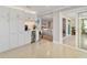Bright kitchen features white cabinetry, beverage cooler, and seamless access to other rooms at 2610 Jefferson Cir, Sarasota, FL 34239