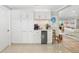 Bright kitchen features white cabinetry, stainless steel appliances, and seamless access to other rooms at 2610 Jefferson Cir, Sarasota, FL 34239