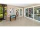 Bright and spacious lanai with modern table set, sliding glass doors, and neutral decor at 2610 Jefferson Cir, Sarasota, FL 34239