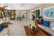 Bright lanai features a cozy seating area, modern table and chairs, and sliding glass doors at 2610 Jefferson Cir, Sarasota, FL 34239