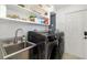 Laundry room has new washer, dryer, stainless steel sink and lots of storage at 2610 Jefferson Cir, Sarasota, FL 34239