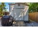 Outdoor shed, great for storage, featuring neutral siding, accessed via a wooden ramp and backyard space at 2610 Jefferson Cir, Sarasota, FL 34239