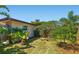 Lush side yard featuring tropical foliage including banana trees, offering a private outdoor setting at 2610 Jefferson Cir, Sarasota, FL 34239