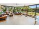 Spacious sunroom with floor-to-ceiling windows and comfortable seating areas at 2610 Jefferson Cir, Sarasota, FL 34239