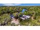 Breathtaking aerial view of the residence on the river, surrounded by lush greenery and featuring a private dock at 2707 162Nd E Ave, Parrish, FL 34219
