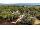 Aerial view of a home with a private dock and nearby kayak facility, surrounded by lush greenery and water at 2707 162Nd E Ave, Parrish, FL 34219