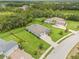 Aerial view of a home with manicured lawn, fenced backyard, and mature trees at 2707 162Nd E Ave, Parrish, FL 34219