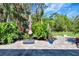 Paver patio with backyard greenery, an umbrella, and lush landscaping at 2707 162Nd E Ave, Parrish, FL 34219