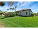 Well-maintained backyard with lush lawn, privacy fence, and tropical landscaping at 2707 162Nd E Ave, Parrish, FL 34219