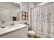 Bright bathroom featuring a modern vanity, framed prints, and a floral-patterned shower curtain at 2707 162Nd E Ave, Parrish, FL 34219