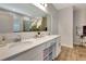 A well-lit bathroom has a double sink vanity and a clear view of the glass-enclosed shower at 2707 162Nd E Ave, Parrish, FL 34219